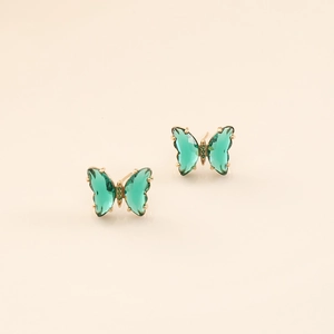 Macro view of green crystal butterfly earrings with fine gold plating and micro-pave stones