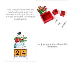 Detail of wooden Christmas countdown calendar with snowman, reindeer and date blocks