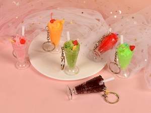 Detailed close-up of six colorful miniature sundae keychains in pastel dream settings