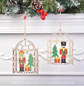 Detail of wooden nutcracker soldier ornaments with green pine branches on white fireplace