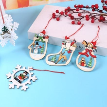 Flat lay of painted wooden Christmas ornaments featuring Santa, snowman, and reindeer figures