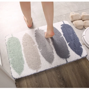 Detail showing plush feather pattern bath mat with anti-slip texture in a bathroom setting
