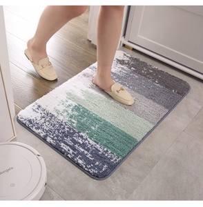 Detail of plush microfiber bath mat with gradient blue and green geometric pattern