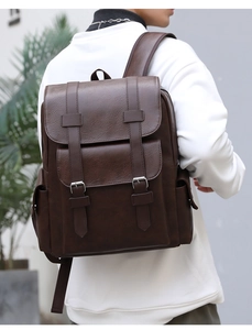 Rear view of model wearing dark brown faux leather backpack with rich vintage texture
