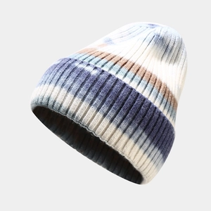 Macro shot of blue and brown tie-dye striped knit beanie with detailed texture