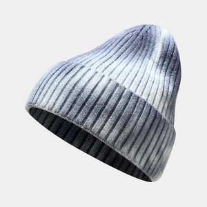 Detail of grey and white gradient tie-dye knit beanie with ribbed texture and rolled edge