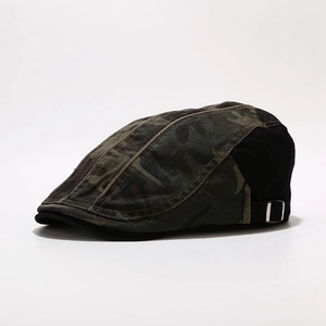 Detail of camouflage flat cap showing side metal adjustment buckle and cotton texture