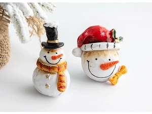 Close-up of resin snowman Christmas table ornaments with hand-painted details on white base