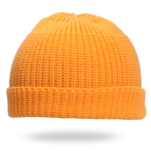 Detailed close-up of bright orange knit texture and rolled cuff on a winter beanie