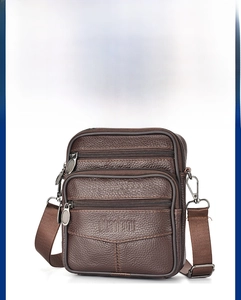 Close-up of deep brown lychee grain leather crossbody bag with multiple zipped pockets