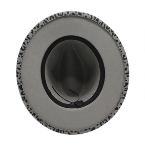 Macro view of wide brim jazz hat interior with adjustable strap and leopard print edge