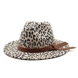 Detailed view of leopard print fedora hat with brown leather band and bow decoration