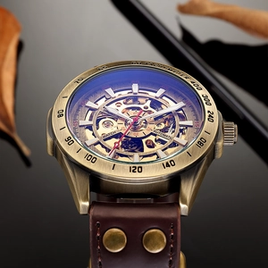 Close-up of skeleton dial and bronze mechanical watch with brown leather strap