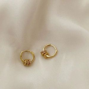 Boucles d'oreilles créoles dorées avec triple anneaux en zircon sur soie champagne douce