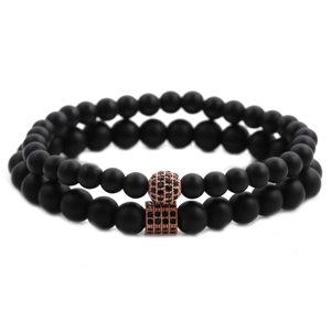 Detail of matte black beads bracelet set with rose gold crown and pavé zircon ball
