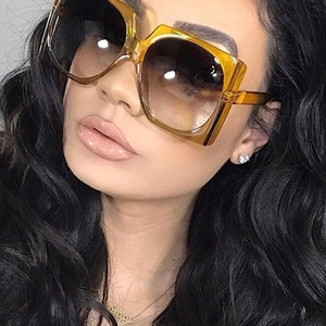 Close-up of amber square oversized sunglasses on model showing trendy fit and side profile