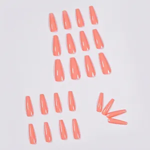 Glossy coral pink long coffin press on nails in 20 pieces set on white background