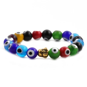Detailed view of colorful evil eye beads and golden buddha head on an elastic bracelet