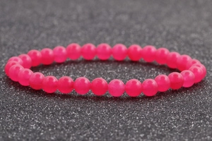 Detalle macro de cuentas de piedra natural rosa de 6mm en una pulsera elástica brillante