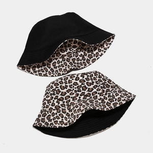Double-sided reversible canvas bucket hat featuring black solid and leopard print patterns