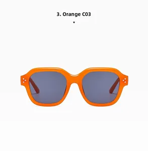 Close-up of orange retro square sunglasses with silver rivet accents and dark lenses