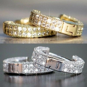 Close-up of gold and silver U-shaped earrings with full micro-pave cubic zirconia