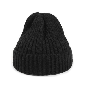Black cable knit beanie hat with ribbed cuff for winter warmth on white background