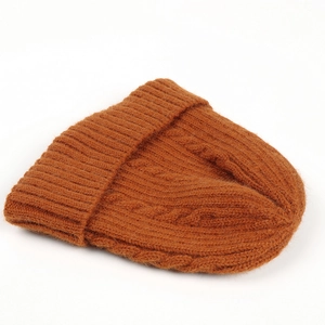 Winter cable knit beanie in caramel rust orange with warm ribbed cuff on white background