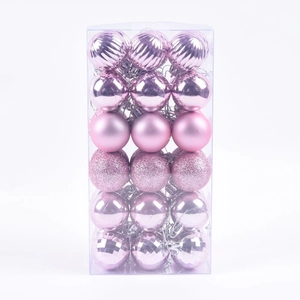 Close-up of pink Christmas balls in a storage box with matte and glitter finishes