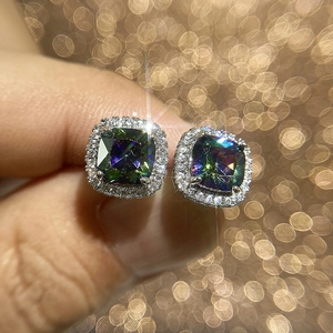 Macro shot of silver square stud earrings with rainbow zircon stones and halo crystals
