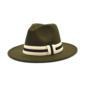 Close-up of olive green wool fedora with a beige woven band and wide brim detail