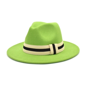Detail of the high-saturation fruit green felt fedora hat with a striped decorative band
