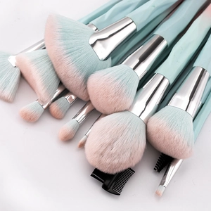 Close-up of soft pink and blue gradient bristles on professional makeup brushes set