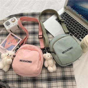 Nylon mini crossbody bags in pink and green with bear charms and brand logo