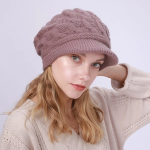 Detalle del tejido de punto trenzado de una gorra de lana rosa viejo para mujer