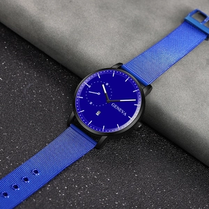 Macro detail of blue Milanese mesh strap and black case on a minimalist quartz watch