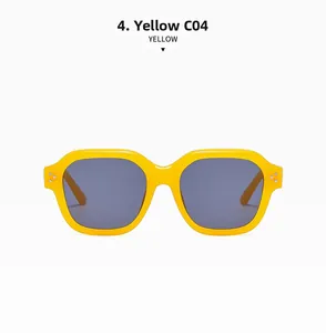 Detail of yellow square sunglasses frame with metallic rivets and dark lenses