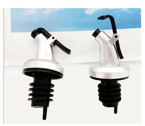 Detailed view of silver oil pourer spouts with black rubber seals for kitchen bottles