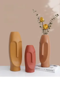 Macro shot of Nordic ceramic face vases showing matte frosted texture and Morandi colors