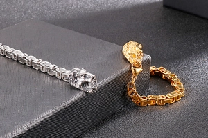 Detailed view of gold and silver lion head bracelets with Byzantine square chains