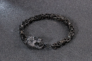 Detailed close-up of a matte black lion head bracelet with Byzantine square link chain