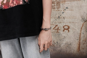 Detail of vintage lion head bracelet with oxidized silver finish on a male wrist