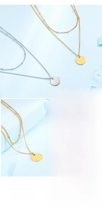Detail of layered gold and silver snake chains with polished round disc pendants