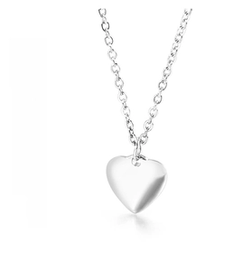 Macro shot of polished silver heart pendant necklace showing high-gloss texture