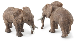 Detailed close-up of realistic elephant figurines showing lifelike skin texture and ivory tusks