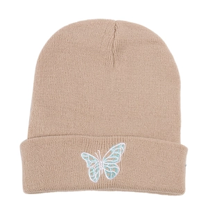 Close-up of butterfly embroidery on a beige cuffed knit beanie hat for winter