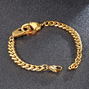 Detailed view of golden handcuff Cuban link bracelet with a secure lobster clasp