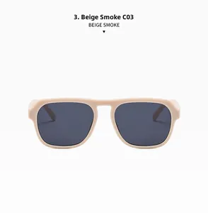 Dettaglio degli occhiali da sole rettangolari beige con lenti grigio fumo e protezione UV