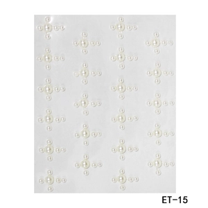 Macro detail of white pearl face stickers in cross pattern with clear adhesive backing