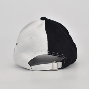 Detail view of the black and white split color baseball cap with adjustable metal buckle
